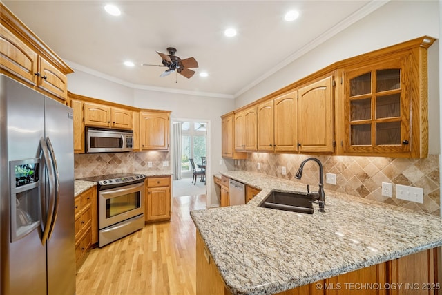 7534 S Hudson Pl, Tulsa, OK 74136 - kitchen with appliances with stainless steel finishes, a ceiling fan, a peninsula, glass insert cabinets, and light stone counters