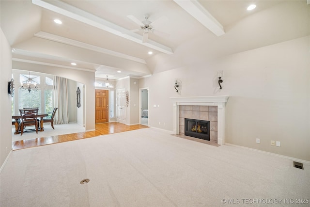 7534 S Hudson Pl, Tulsa, OK 74136 - unfurnished living room featuring carpet, a tiled fireplace, recessed lighting, a chandelier, and ceiling fan