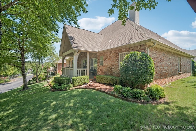 7534 S Hudson Pl, Tulsa, OK 74136 - view of side of property featuring brick siding, a chimney, a yard, and roof with shingles