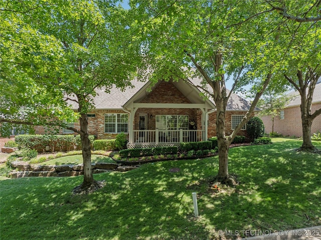 7534 S Hudson Pl, Tulsa, OK 74136 - view of front of property with brick siding, a front lawn, and a shingled roof