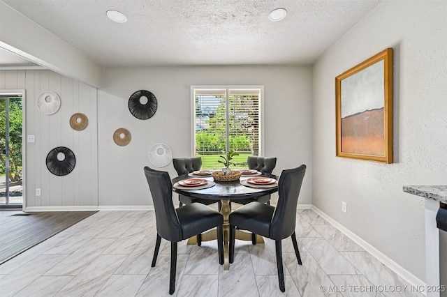 3350 E 54th St, Tulsa, OK 74135 - dining space with plenty of natural light, light marble finish floors, and a textured ceiling