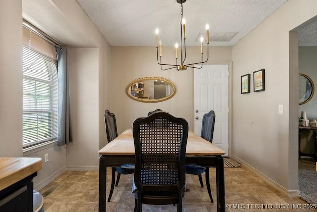 22 Mary St, Kiefer, OK 74041 - dining area with a chandelier, a textured ceiling, and stone finish flooring