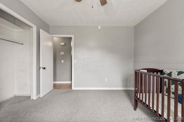 22 Mary St, Kiefer, OK 74041 - unfurnished bedroom with carpet flooring, a textured ceiling, a nursery area, a ceiling fan, and a closet