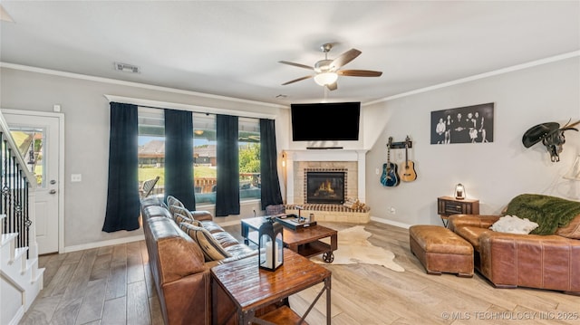 21820 Summit Trl, Claremore, OK 74019 - living area with stairway, ornamental molding, a ceiling fan, wood finished floors, and a brick fireplace