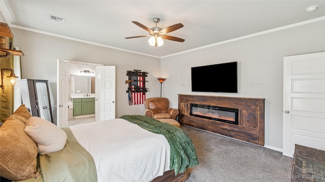 21820 Summit Trl, Claremore, OK 74019 - bedroom with crown molding, carpet flooring, a glass covered fireplace, connected bathroom, and ceiling fan