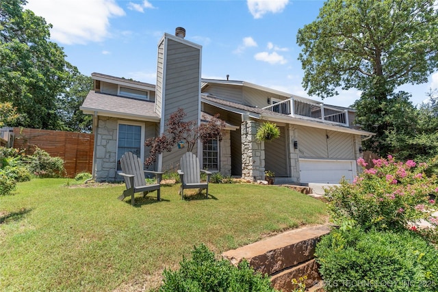 9622 S Maplewood Ave, Tulsa, OK 74137 - rear view of property with a chimney, stone siding, a balcony, an attached garage, and a shingled roof