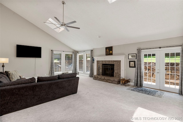 9622 S Maplewood Ave, Tulsa, OK 74137 - carpeted living room featuring a ceiling fan, high vaulted ceiling, plenty of natural light, french doors, and a stone fireplace