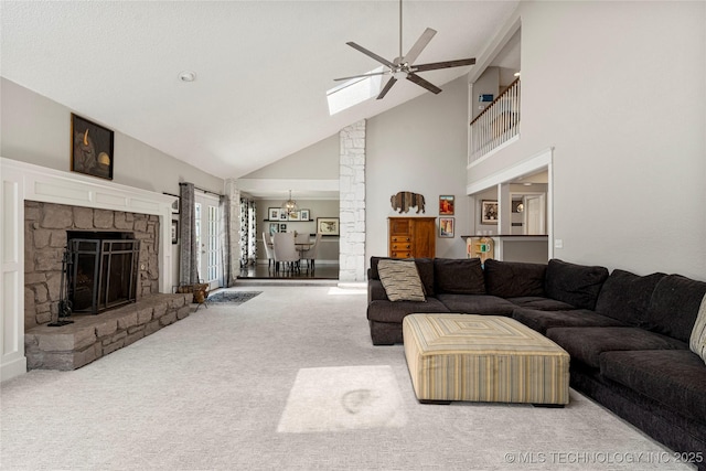 9622 S Maplewood Ave, Tulsa, OK 74137 - living room with high vaulted ceiling, a ceiling fan, carpet flooring, a skylight, and a fireplace