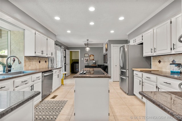 9622 S Maplewood Ave, Tulsa, OK 74137 - kitchen featuring appliances with stainless steel finishes, a kitchen island, ornamental molding, recessed lighting, and tasteful backsplash