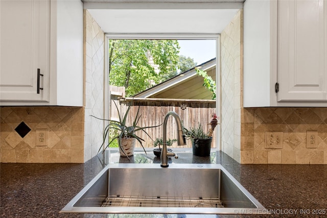 9622 S Maplewood Ave, Tulsa, OK 74137 - detailed view of white cabinetry, tasteful backsplash, and dark stone countertops