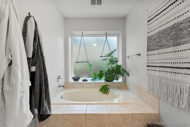 9622 S Maplewood Ave, Tulsa, OK 74137 - full bathroom featuring a garden tub and a textured ceiling