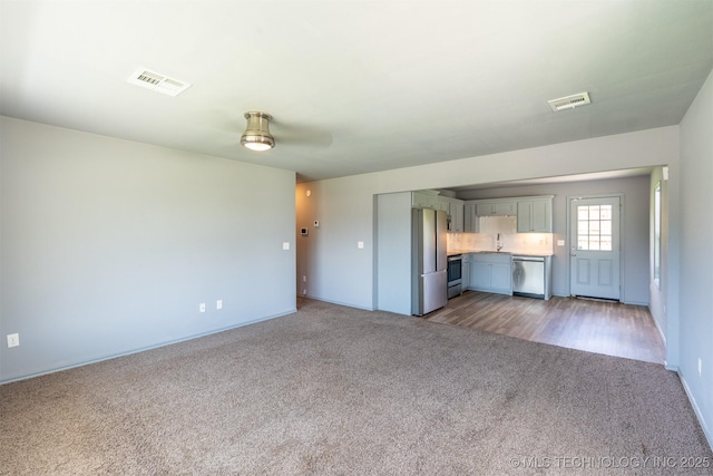 104 Gardenia Pl, Mannford, OK 74044 - unfurnished living room featuring carpet flooring and ceiling fan