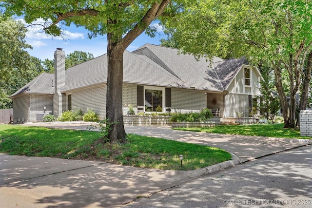 4335 E 87th St, Tulsa, OK 74137 - view of front facade with a chimney, brick siding, and a front lawn