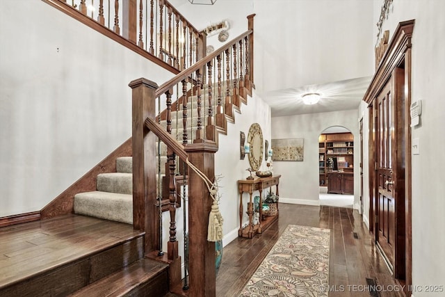 4335 E 87th St, Tulsa, OK 74137 - entrance foyer with arched walkways, a towering ceiling, hardwood / wood-style flooring, and stairs