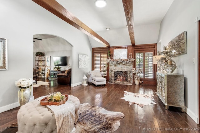4335 E 87th St, Tulsa, OK 74137 - living room featuring a warm lit fireplace, hardwood / wood-style floors, and arched walkways