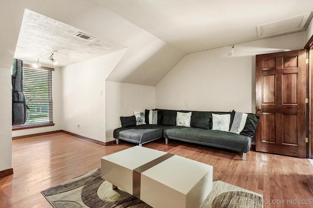 4335 E 87th St, Tulsa, OK 74137 - living room featuring wood finished floors, attic access, and vaulted ceiling