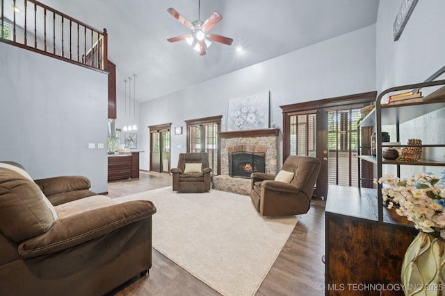 10102 N 147th E Ave, Owasso, OK 74055 - living area featuring high vaulted ceiling, a ceiling fan, a fireplace, and wood finished floors