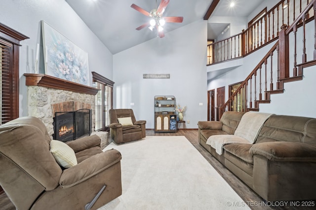 10102 N 147th E Ave, Owasso, OK 74055 - living room featuring a fireplace, wood finished floors, high vaulted ceiling, ceiling fan, and stairs