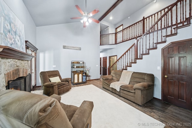 10102 N 147th E Ave, Owasso, OK 74055 - living area featuring high vaulted ceiling, wood finished floors, ceiling fan, stairway, and a warm lit fireplace