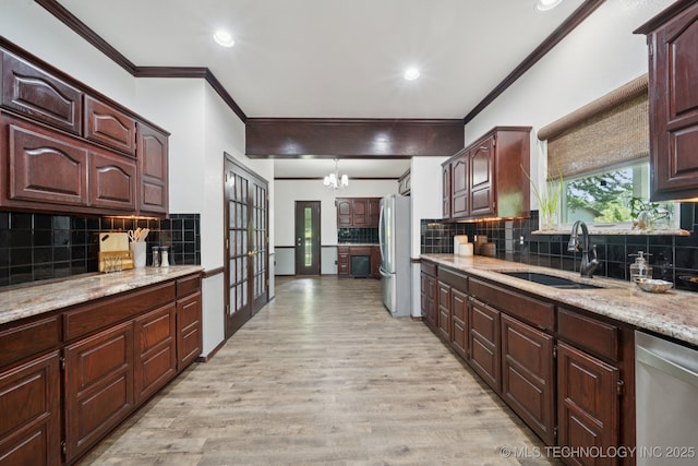 10102 N 147th E Ave, Owasso, OK 74055 - kitchen with stainless steel appliances, ornamental molding, a chandelier, light wood-style floors, and tasteful backsplash