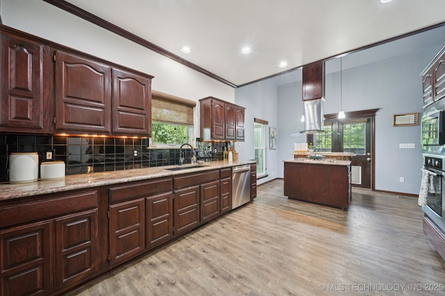 10102 N 147th E Ave, Owasso, OK 74055 - kitchen with stainless steel appliances, light wood finished floors, decorative backsplash, dark brown cabinetry, and recessed lighting