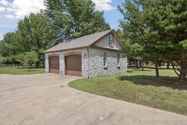 10102 N 147th E Ave, Owasso, OK 74055 - view of side of property featuring stone siding, a detached garage, and a shingled roof