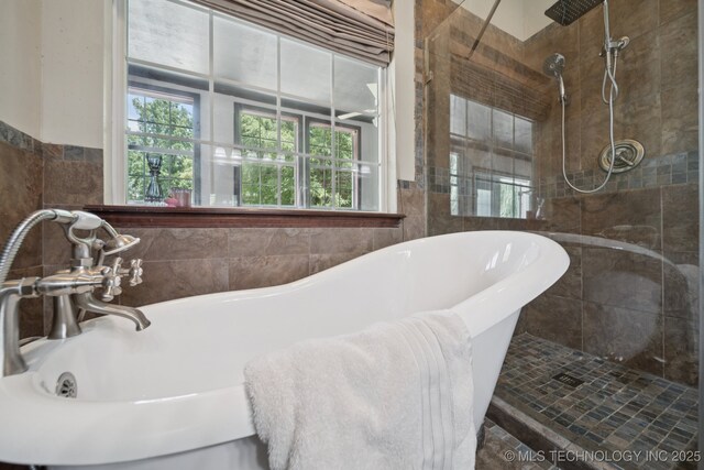 10102 N 147th E Ave, Owasso, OK 74055 - bathroom featuring a freestanding tub, tile walls, and tiled shower