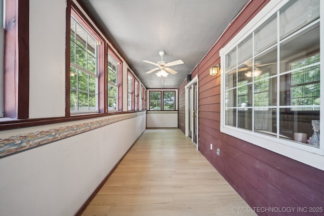 10102 N 147th E Ave, Owasso, OK 74055 - corridor with light wood-type flooring and wood walls
