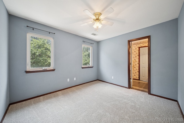 10102 N 147th E Ave, Owasso, OK 74055 - carpeted empty room featuring plenty of natural light and ceiling fan