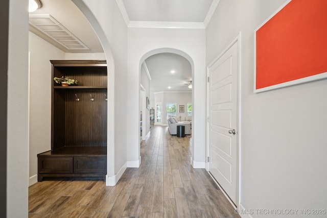 2618 W 115th St S, Jenks, OK 74037 - hallway featuring ornamental molding, wood finished floors, and arched walkways