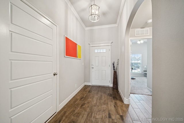 2618 W 115th St S, Jenks, OK 74037 - entryway featuring arched walkways, dark wood-style floors, crown molding, and a chandelier