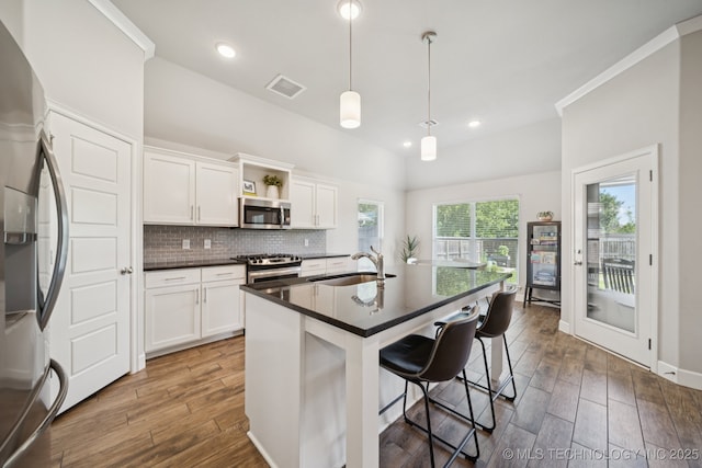 2618 W 115th St S, Jenks, OK 74037 - kitchen with appliances with stainless steel finishes, dark countertops, wood finished floors, backsplash, and recessed lighting