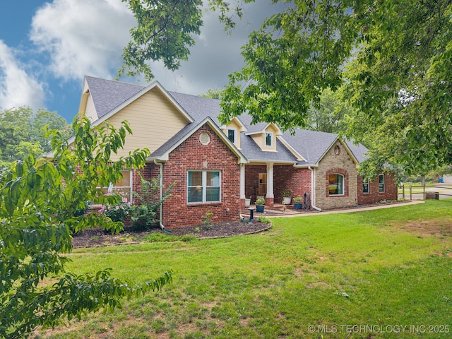 4852 E Redbud Dr, Claremore, OK 74019 - view of front facade featuring brick siding, a front yard, and a shingled roof