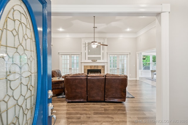 4852 E Redbud Dr, Claremore, OK 74019 - living area with a ceiling fan, wood finished floors, a tile fireplace, and ornamental molding