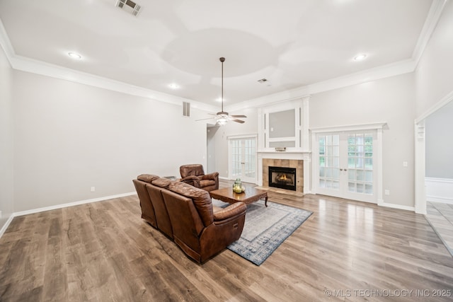 4852 E Redbud Dr, Claremore, OK 74019 - living room featuring wood finished floors, a fireplace, ceiling fan, crown molding, and recessed lighting