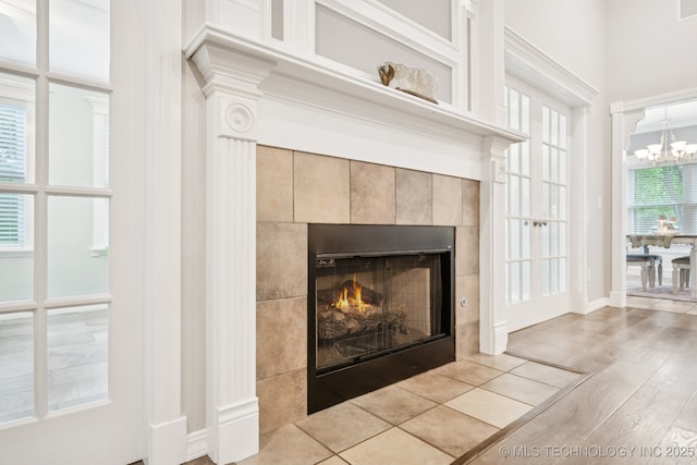 4852 E Redbud Dr, Claremore, OK 74019 - detailed view of wood finished floors, a fireplace, and a chandelier