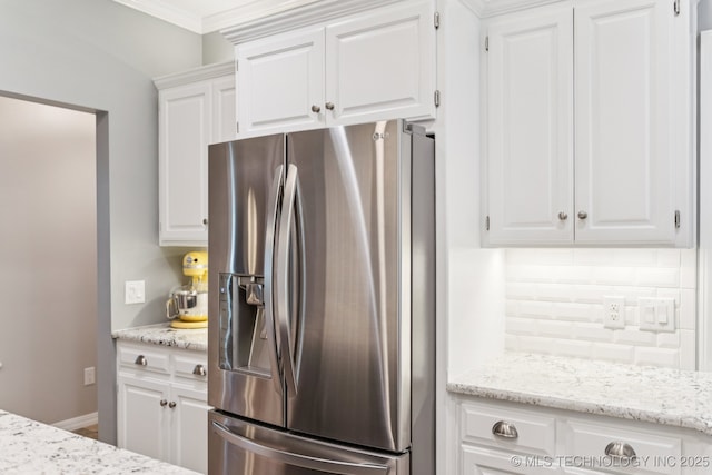 4852 E Redbud Dr, Claremore, OK 74019 - kitchen featuring stainless steel fridge, decorative backsplash, white cabinetry, light stone counters, and crown molding