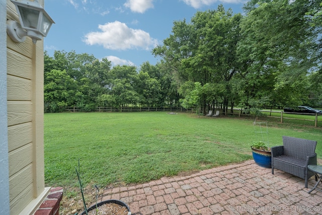 4852 E Redbud Dr, Claremore, OK 74019 - fenced backyard with a patio area and view of scattered trees