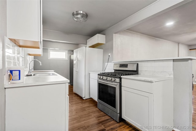 6264 E Latimer St, Tulsa, OK 74115 - kitchen featuring gas stove, white refrigerator with ice dispenser, white cabinets, and dark wood-type flooring