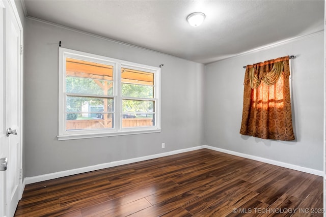 6264 E Latimer St, Tulsa, OK 74115 - spare room featuring crown molding and dark wood-style floors