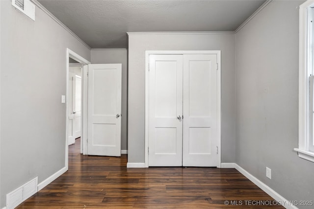 6264 E Latimer St, Tulsa, OK 74115 - unfurnished bedroom featuring dark wood-style floors, ornamental molding, and a closet