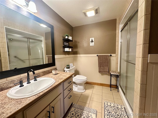 215 Belt St, Eufaula, OK 74432 - bathroom featuring vanity, a stall shower, tile patterned floors, and a wainscoted wall