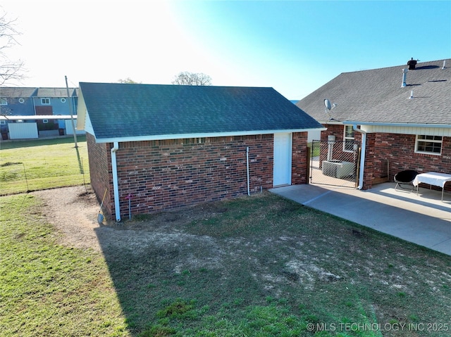 215 Belt St, Eufaula, OK 74432 - rear view of property featuring brick siding, a patio, and roof with shingles