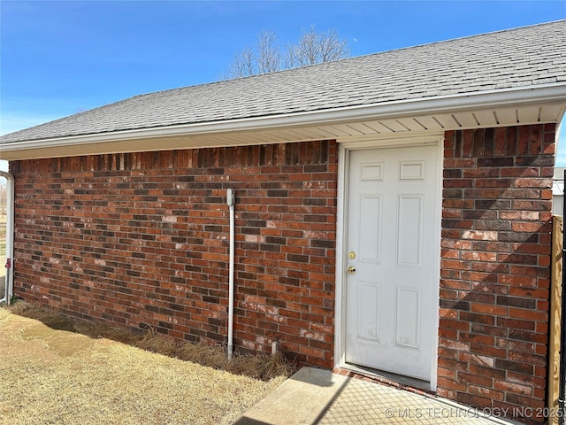 215 Belt St, Eufaula, OK 74432 - view of exterior entry featuring roof with shingles and brick siding