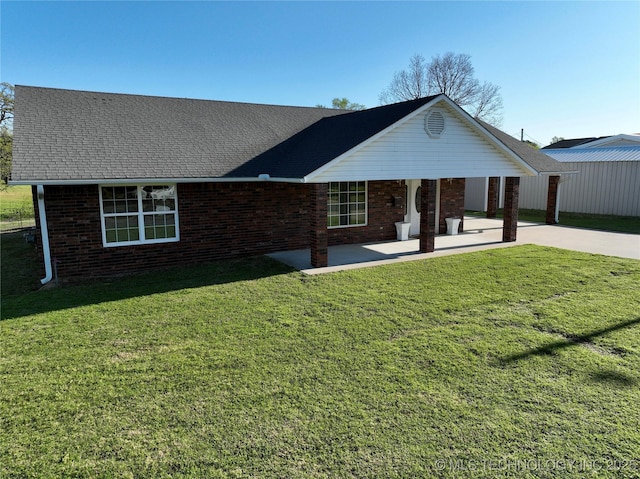 215 Belt St, Eufaula, OK 74432 - view of front of house featuring brick siding, a front yard, a patio, and driveway