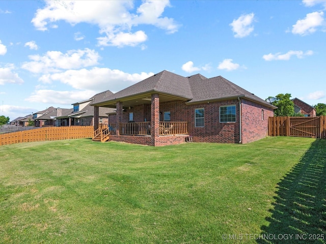 5719 Nottingham Pl, Bartlesville, OK 74006 - rear view of house with brick siding, a fenced backyard, and a shingled roof