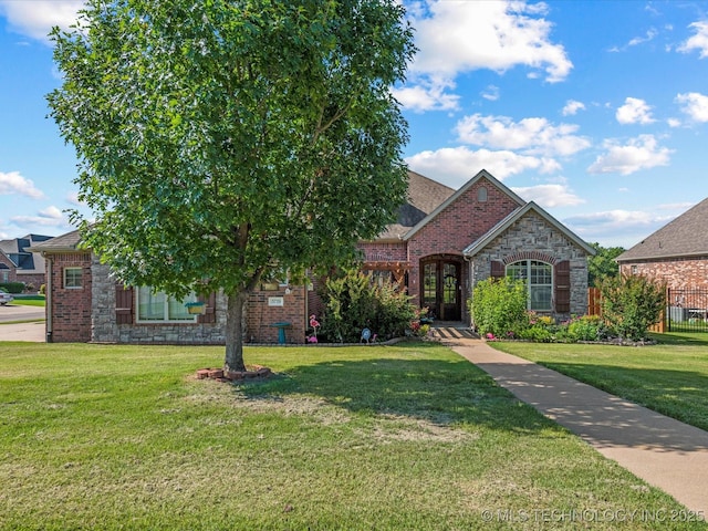 5719 Nottingham Pl, Bartlesville, OK 74006 - view of front of home with a front lawn, brick siding, french doors, and stone siding