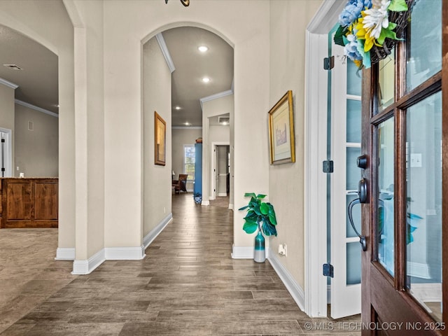 5719 Nottingham Pl, Bartlesville, OK 74006 - foyer entrance with arched walkways, ornamental molding, and wood finished floors