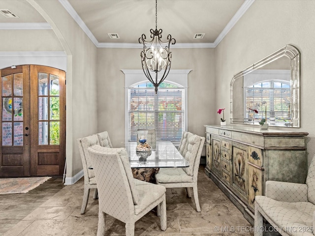 5719 Nottingham Pl, Bartlesville, OK 74006 - dining area with a chandelier, arched walkways, stone tile flooring, french doors, and crown molding