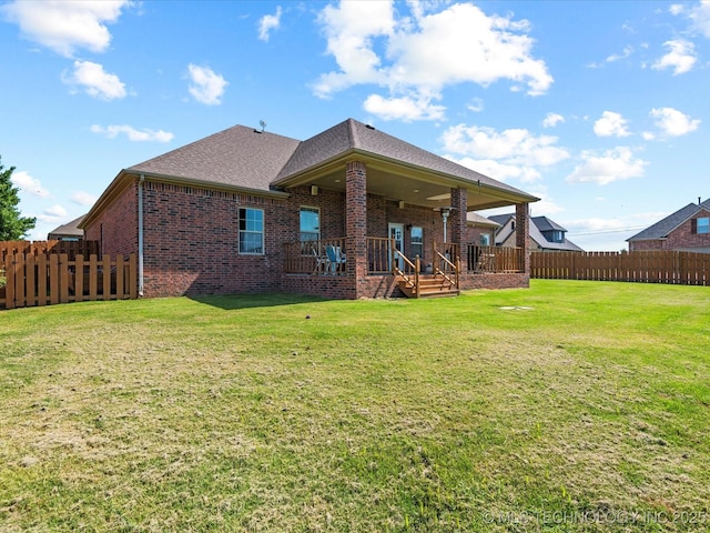 5719 Nottingham Pl, Bartlesville, OK 74006 - back of house featuring brick siding, a fenced backyard, and a shingled roof